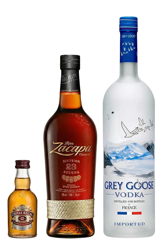 Botellas de Ron Zacapa 23 y Vodka Grey Goose de 1 litro junto a miniatura de Chivas 12 sobre fondo blanco.