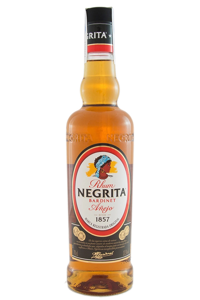 Botella de 1 litro de Ron Negrita, un ron suave con perfil clásico y especiado. Ideal para uso intensivo en coctelería. Color ámbar claro, aroma a vainilla, caramelo y especias suaves. Sabor redondo, ligero y con final dulce. Elaborado con melaza de caña y destilación continua. Presentado en botella de vidrio con etiqueta distintiva.
