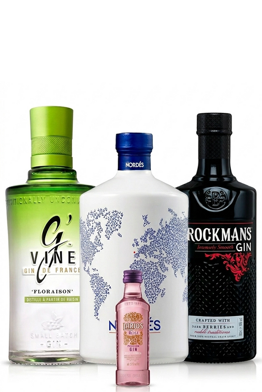 Botellas de ginebra G'Vine Floraison, Nordés y Brockmans junto a la miniatura de regalo Larios Rosé presentadas sobre fondo blanco.